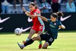 Kansas City Current midfielder Lo'eau LaBonta (10) and Portland Thorns FC midfielder Jessie Fleming (21) battle for control of the ball during an NWSL soccer match at CPKC Stadium, Saturday, March 16, 2024, in Kansas City, Mo.