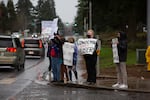 Students outside the Evergreen Public Schools administrative offices in east Vancouver wave signs condemning sexual abuse. Students said the school has recently failed to respond to reports of harassment and abuse.