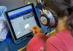 FILE: A student participates in Ignite! Reading, a virtual tutoring program at Durham Elementary in Tigard, on Nov. 7, 2022. 