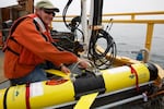 OSU oceanographer Jack Barth prepares a glider that will spend weeks flying through the ocean, collecting data on ocean acidification and oxygen levels.
