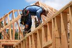 A worker works on the roofing structure of new home under construction, Tuesday, July 15, 2025, in Richardson, Texas.