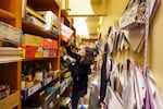 David Douglas High School art teacher Maria Galati pulls out special paper from her classroom’s supply closet. Galati teaches several classes at the high school, including calligraphy and crafts.