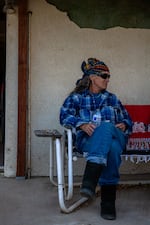 Karen Parker rests on her porch in Boulevard, Calif., on a day off from volunteering at the camps in Jacumba. A retired social worker with first-aid training, Parker frequently goes down to the camps to treat migrants who need care.
