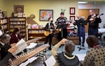 Musicians invite Ikoi no Kai members to sing along in Portland, Ore., on Dec. 17, 2024. (From left to right) Mary and John Crull play the guitars, Hiroshi Iwai plays the flute and Rick March plays the mandolin in the background.