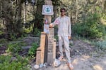 Pacific Crest Trail hiker Ian Irwin stands next to a trail monument he and fellow hikers built on July 29, 2026, near Rainy Pass, Wash.