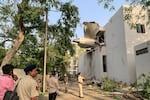 The back of Air India Flight 171 juts out of a building after the Boeing 787-8 Dreamliner crashed in a residential area near the airport in Ahmedabad on Thursday.