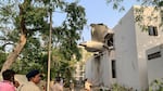 The back of Air India Flight 171 juts out of a building after the Boeing 787-8 Dreamliner crashed in a residential area near the airport in Ahmedabad on Thursday.