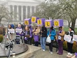 Tricia Schroeder of SEIU Local 925, center, speaks at a Jan. 19, 2026 rally of early learning and child care professionals who seek better wages and benefits and oppose proposed cuts to programs that could leave families with fewer child care options.