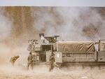 An Israeli army self-propelled howitzer fires rounds near the border with Gaza in southern Israel on Oct. 11, 2023.