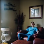 Josh Haggard sits for a portrait in his living room on Jan. 24, 2020, in Wilsonville, Ore. Haggard's mom, worried that her son might hurt himself, petitioned a judge to have his guns taken away using the state's new extreme risk protection orders but Haggard says the experience only worsened his mental health.  