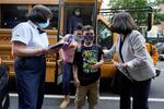 Students are greeted as they arrive at PS811 in New York, Monday, Sept. 13, 2021. School started Monday for about a million New York City public school students in the nation's largest experiment of in-person learning during the coronavirus pandemic.