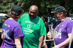 A Juneteenth volunteer, center, talks with members of The Beat Goes On marching band.