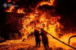 In this photo provided by the Ukrainian Emergency Service, emergency services personnel work to extinguish a fire following a Russian attack in Kharkiv region, Ukraine, Saturday, July 5, 2025.