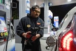 An attendant prepares to fill a customer's tank at a gas station on Wednesday, May 6, 2026, in Portland, Ore.