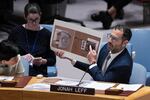 Jonah Leff, executive director at Conflict Armament Research (CAR), shows pictures of debris from armaments used by Russia, found in Ukraine, during a Security Council meeting at United Nations headquarters on June 28, 2024. CAR's findings indicate the weapons were made in North Korea.