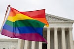 FILE - Supporters of the LGBT wave their flag in front of the U.S. Supreme Cour, Oct. 8, 2019, in Washington.