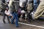 Protesters are arrested by federal agents near the scene where Renee Macklin Good was fatally shot by an ICE officer last January in Minneapolis.