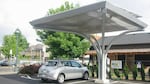 Will putting solar panels on top of electric car charging stations make them more cost-effective?