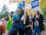Winslow Stoertz, 8, left, hugs her teacher Liza Springgate, a third-grade teacher at Abernethy Elementary School, on the first day of the Portland Public Schools strike in Portland, Ore., Nov. 1, 2023.
