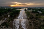 The sun sets over the Guadalupe River in Texas.