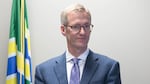 Mayor Ted Wheeler stands next to the podium during a press conference with Portland Police Chief Danielle Outlaw.