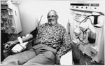 A black and white photo of Harrison giving blood.