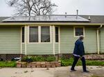 Rev. Charles Duplessis walks by his solar panel-topped house in New Orleans' Lower Ninth Ward neighborhood on Friday, Feb. 25, 2022. The Environmental Protection Agency this week awarded the city nearly $50 million to help pay for installing solar on low to middle income homes.