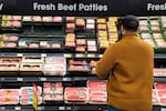 In this handout image, Bryan Vance compares the prices of 80/20 ground beef at a Newberg grocery store on April 10, 2026.
