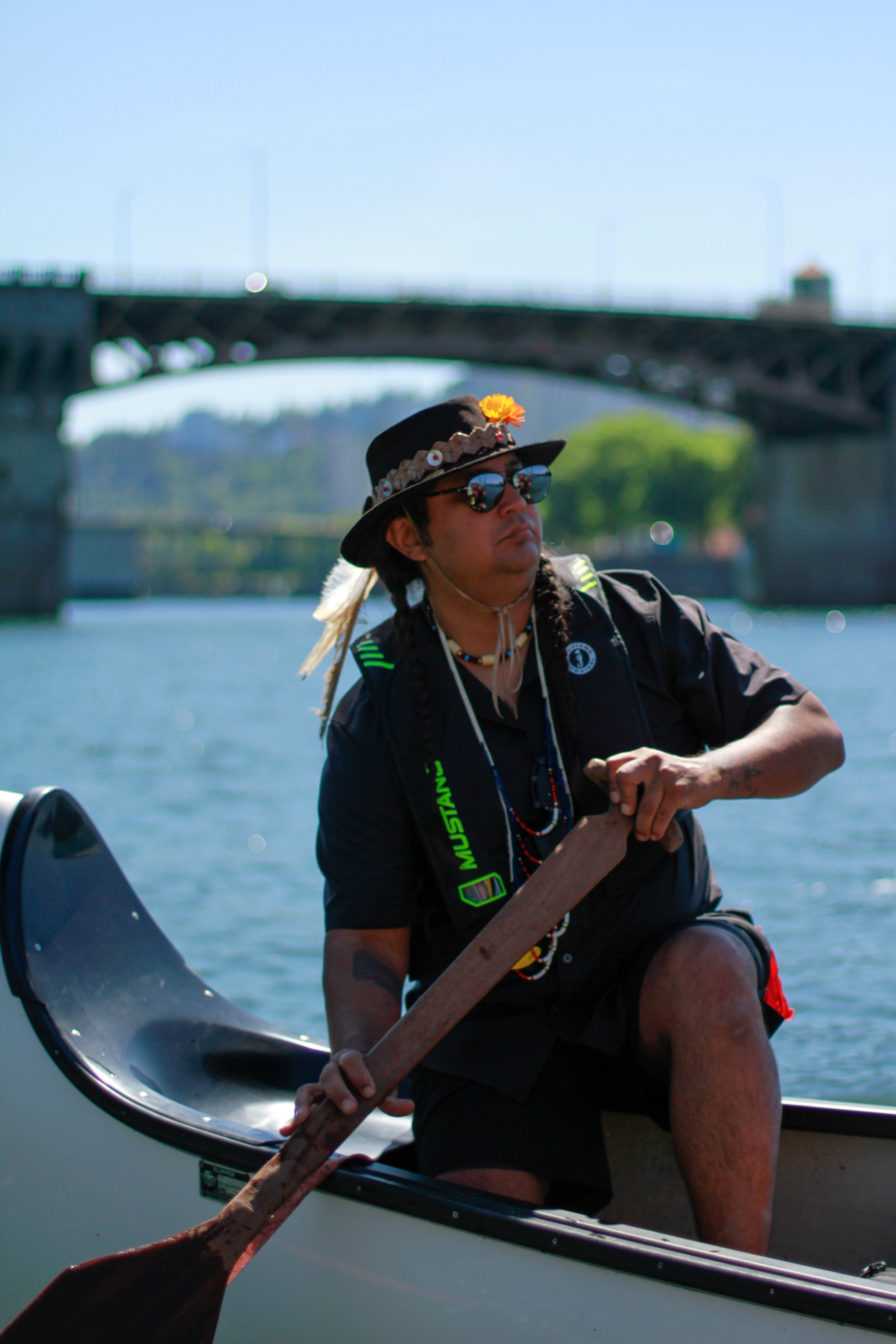 Lukas Angus, skipper for the 7 Waters Canoe Family, guided the canoe full of Indigenous youth from the middle of the Willamette River to Duckworth Memorial Dock. Angus, who is Niimiipuu and Cayuse on his father’s side and Tlingit and Haida on his mother’s side, emphasized the importance of prayer while pulling the canoe, especially for the “letting go” ceremony.