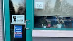 Signs in the window of a classroom at Heritage Elementary in Woodburn, Ore., say "Woodburn teachers don't want to strike, but we will." Signs hang across the district in English, Spanish and Russian.