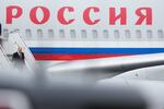 Russian President Vladimir Putin walks down steps as he exits his airplane upon arriving at Joint Base Elmendorf-Richardson.