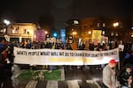 Protesters stand behind a large banner at the west end of the Burnside Bridge on Jan. 20, 2017.