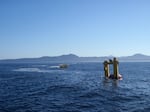 The OSU Ocean Sentinel test facility buoy (left) and the WET-NZ wave energy conversion device (right) during acoustic recording and monitoring sound levels at the site during device testing.