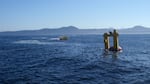 The OSU Ocean Sentinel test facility buoy (left) and the WET-NZ wave energy conversion device (right) during acoustic recording and monitoring sound levels at the site during device testing.