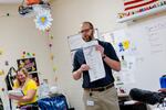 Chief Deputy Clerk Abe Dane holds a sample ballot to educate students on the election process at Reading High School on Oct. 4, 2024 in Hillsdale, Mich.