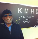 Ahmad Jamal stands in front of the KMHD signage at the KMHD studios in 2014.