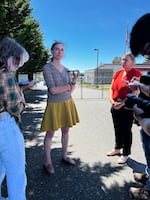 U.S. Rep. Maxine Dexter, D-Ore., second from left, speaks to reporters in front of the Customs and Border Protection station near Ferndale, Wash., where Kenia Jackeline Merlos and her four children have been detained.
