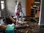 Hurricane Ian killed more than 150 people when it slammed into Florida in 2022. Here, Fort Myers, Fla., resident Stedi Scuderi looks over her apartment after it was inundated by flood water from the storm.