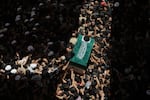 The coffin of the late Iranian Supreme Leader Ayatollah Ali Khamenei is carried by mourners to the Imam Ali Shrine in Najaf, Iraq, Wednesday, July 8, 2026.