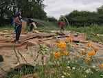 Shiny Flanary, left, Letty Martinez, and Xochitl Garnica, right, clear a section of land on their 2-acre farm on Sauvie Island.