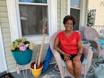 Kim Sudderth, a local climate activist and member of Norfolk's Planning Commission, sits on the porch of her home in the Berkley neighborhood in July.