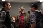 Joe Kent. left, talks with a couple of people who attended his speech in Longview, Wash., on Oct. 14, 2021. Kent, who is endorsed by former President Donald Trump, is vying to unseat U.S. Rep. Jaime Herrera Beutler, R-Battle Ground.