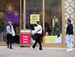 Shoppers walk past sale signs on Black Friday 2022 in Alpharetta, Ga.