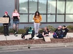 Several students sit in front of Springfield School District's headquarters on Jan. 26, 2026, after marching through downtown Springfield to protest layoffs.