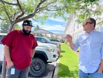 Kevin Wilson, left, stands with Rick Russell, right, who is a pastor at Mountain View Fellowship and the director of Redmond’s Safe Parking program. The program helps vetted participants park their vehicles at designated sites overnight and assists people like Wilson, who struggled with houselessness before recently moving into an apartment.