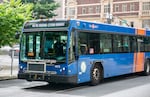 FILE: A passenger waves from inside a TriMet bus in downtown Portland, Ore., June 29, 2024. 