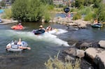 FILE: Tubes pile up after one person flips and swims through the rapids at the Bend Whitewater Park on Aug. 9, 2023.