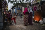Rohingya refugee women and children are seen at Rohingya refugee camp on the occasion of World Refugee Day in New Delhi, India, on June 17, 2023.