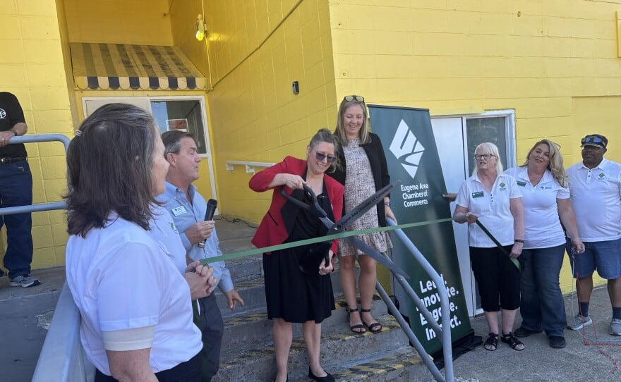 St. Vincent de Paul's Executive Director Bethany Cartledge cuts the ribbon at the opening of the Murnane Family Resource Center on July 8, 2026.