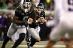 Oregon quarterback Dillon Gabriel (8) looks for an opening during an NCAA college football game against Washington, Saturday, Nov. 30, 2024, in Eugene, Ore.